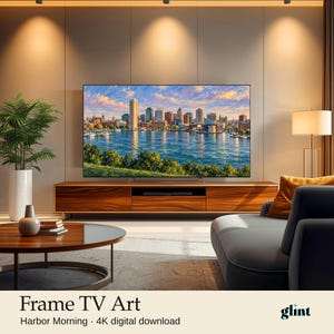 May include: A digital television screen displaying a vibrant impressionist painting of a city skyline across a harbor at sunrise, featuring blue water, green foreground foliage, and a multi-colored sky. Text reads: Frame TV Art Harbor Morning 4K digital download.