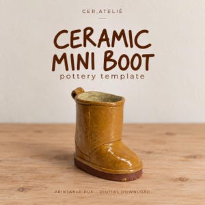 May include: A ceramic mini boot pottery template with the text CER.ATELIÊ, CERAMIC MINI BOOT, pottery template, and PRINTABLE PDF DIGITAL DOWNLOAD. The boot is tan with a dark brown sole and a smooth, glossy finish, featuring a small loop at the back.