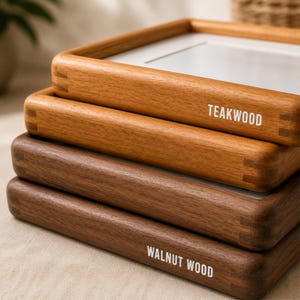 May include: A stack of two square wooden frames with rounded corners and visible finger joints. The top frame is light brown with the text TEAKWOOD printed in white. The bottom frame is dark brown with the text WALNUT WOOD printed in white.