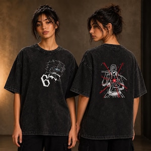 May include: A black acid-wash t-shirt featuring a white graphic of a character with the number 6 on the front. The back displays a detailed illustration of a character holding a sword with red light streaks and a glowing red orb in their hand.