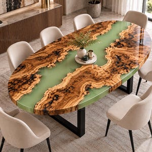 May include: An oval dining table featuring a natural wood slab with a live edge and a central river inlay made of smooth, light green resin. The table is supported by a black metal frame and is surrounded by eight upholstered beige chairs.