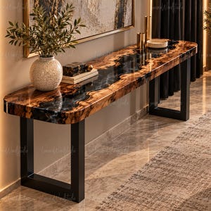 May include: A long console table featuring a live edge wood slab with a central black resin inlay, supported by two black metal U-shaped legs. The surface is polished and glossy, displaying natural wood grain patterns and dark resin.