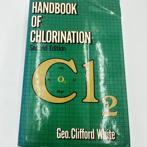 May include: A hardcover book titled Handbook of Chlorination Second Edition by Geo. Clifford White. The cover is green with a black grid pattern and features a large gold chemical symbol Cl2 with smaller chemical formulas printed inside.