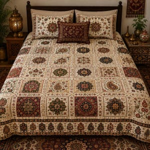 May include: A bedspread and matching pillow shams featuring a grid of square panels with intricate floral, paisley, and geometric patterns in shades of deep red, dark green, navy blue, and cream. A rectangular accent pillow sits in the center.