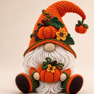 May include: A crocheted gnome figurine featuring a tall orange hat adorned with a small pumpkin, green leaves, and a yellow flower. The gnome has a long white yarn beard, a beige nose, and holds a larger orange pumpkin with a small yellow flower.
