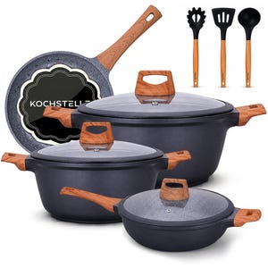 May include: A cookware set featuring dark gray pots and pans with speckled gray interiors, wood-grain patterned handles, and glass lids. The set includes a frying pan with the text KOCHSTELLZ, two lidded pots, a lidded sauté pan, and three black utensils.