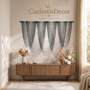 May include: A wall-mounted string curtain featuring a dark grey to white ombre gradient, hung from a black rod. Below, a wooden sideboard with vertical slats holds a vase of flowers and a floral arrangement. Text reads CaelestisDecor ELEVATE YOUR SPACE.
