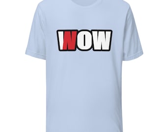 May include: A light blue short-sleeve t-shirt featuring the text "NOW" printed in a bold, black-outlined font across the chest. The letter "N" is colored red, while the letters "O" and "W" are white, all set against a solid light blue background.