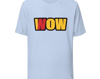 May include: A light blue short-sleeve t-shirt featuring the word WOW printed in a bold, comic-book style font across the chest. The letters are yellow with a red accent on the letter W, all outlined in a thick black border.