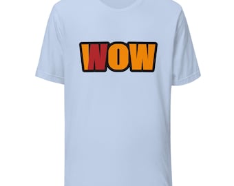 May include: A light blue short-sleeve t-shirt featuring the word WOW printed in a bold, blocky font across the chest. The letters are colored in vibrant orange with a red accent on the letter W, all outlined in a thick black border.