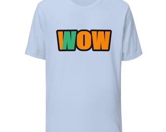 May include: A light blue short-sleeve t-shirt featuring the word WOW printed in a bold, blocky font across the chest. The letter W is green, while the letters O and W are orange, all outlined in a thick black border.