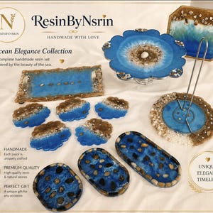 May include: A collection of blue and gold resin home decor items including a scalloped cake stand, a rectangular tray with handles, five cloud-shaped coasters, a paper towel holder, and three oval trays, all featuring embedded natural stones.