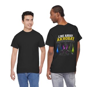 May include: A black short-sleeve t-shirt featuring a graphic on the back. The graphic displays the text "LINE ARRAY AKROBAT" in yellow and white letters above an illustration of a performer with hanging audio speakers and colorful lighting.