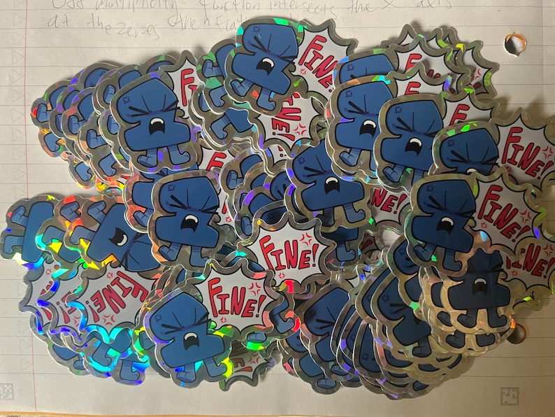 May include: A collection of holographic stickers featuring a blue cartoon character with a frustrated expression. Each sticker has a jagged, comic-style speech bubble background with the red text "Fine!" and small red angry symbols.