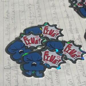 May include: A collection of die-cut stickers featuring a blue cartoon character with an angry expression. Each sticker includes a white speech bubble with a jagged black outline containing the red text FINE! and small red angry symbols.