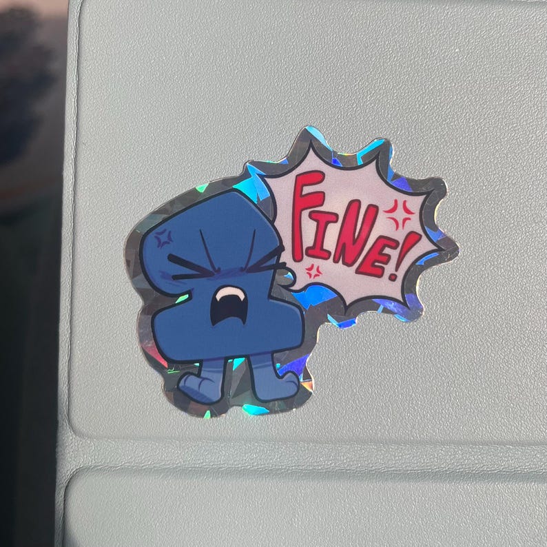 May include: A holographic sticker featuring a blue, anthropomorphic character with an angry expression. The character is depicted with a speech bubble containing the red text "FINE!" and small red star-like symbols indicating frustration.