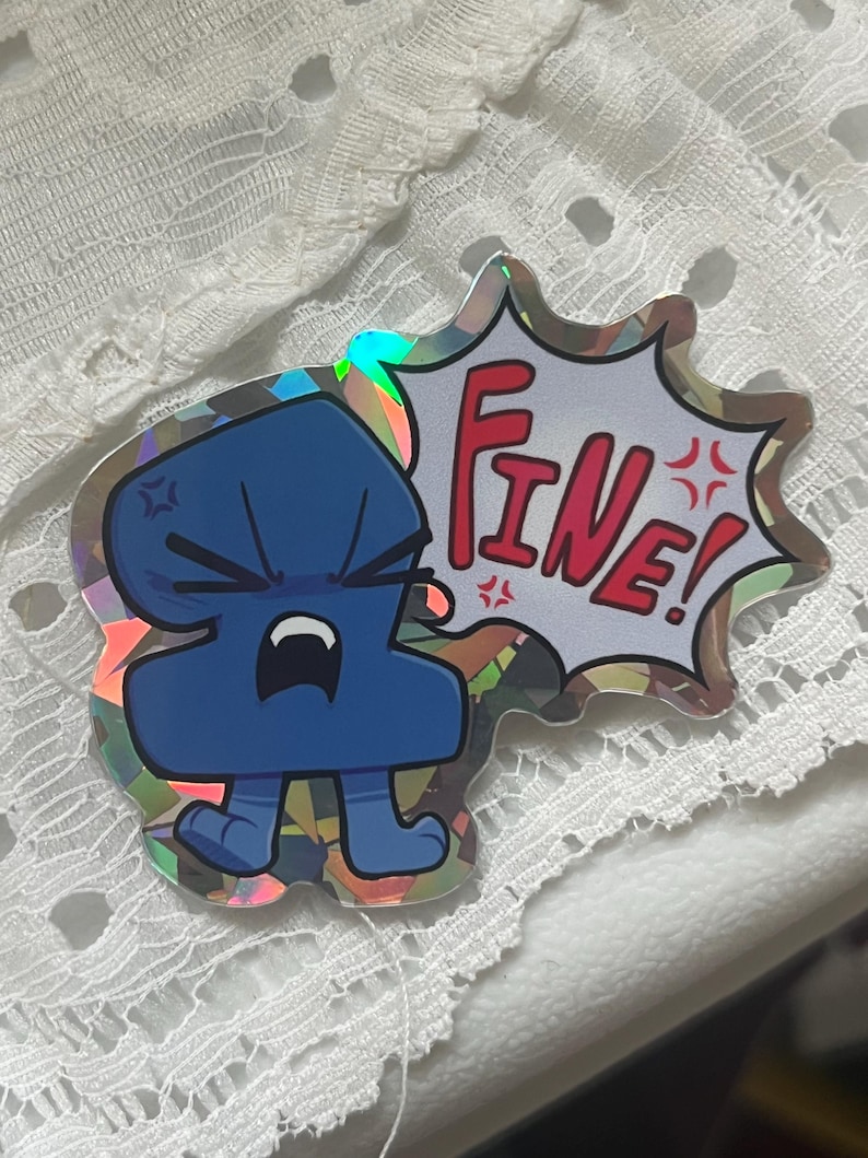 May include: A holographic sticker featuring a dark blue, anthropomorphic number two character with an angry expression, clenched fists, and a speech bubble containing the red text "FINE!" with small red angry symbols surrounding the word.