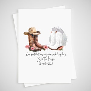 front of wedding card - two pairs of cowboy boots, one dressed as a groom and one dressed as a bride. congratulations on your wedding day is written underneath along with the names of the couple and date of their wedding