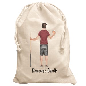 May include: A white canvas drawstring bag with a cartoon illustration of a person holding a pool cue and a glass of beer. The text "Darren's Chalk" is printed on the bag.