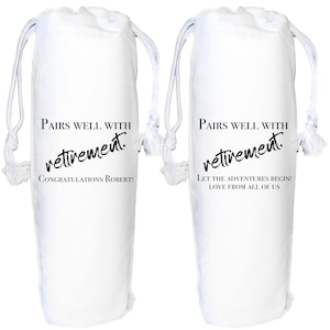 May include: Two white drawstring bags with the text "Pairs well with retirement." One bag says "Congratulations Robert!" and the other says "Let the adventures begin! Love from all of us."