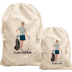 May include: Two beige drawstring bags with a golfer illustration and text. The larger bag says "Linda's Golf Balls" and the smaller bag says "Linda's Tees".