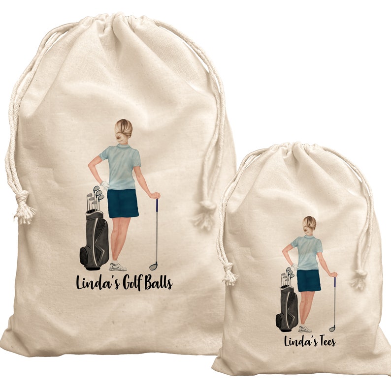 May include: Two beige drawstring bags with a golfer illustration and text. The larger bag says "Linda's Golf Balls" and the smaller bag says "Linda's Tees".