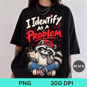 May include: A black t-shirt featuring a graphic of a raccoon wearing a red baseball cap, white t-shirt, and blue jeans, holding a mug with a red angry face. The text reads I IDENTIFY AS A PROBLEM in white and red lettering with red accents.