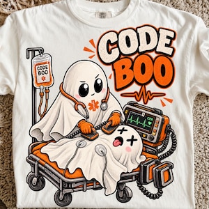 Peut inclure: Un t-shirt blanc avec une illustration représentant un fantôme médecin utilisant un défibrillateur sur un autre fantôme allongé sur un brancard. Le motif inclut une poche à perfusion, un moniteur cardiaque et le texte CODE BOO en orange et noir.