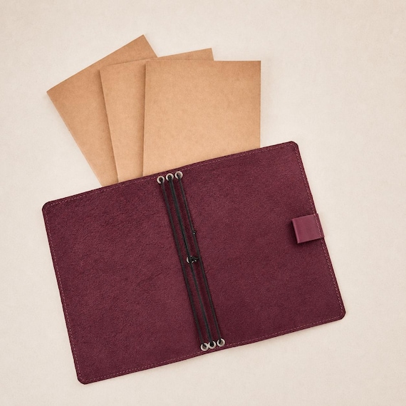 A refillable, monogrammed A5 leather journal cover is the rare stationery gift that lasts years and feels genuinely bespoke.