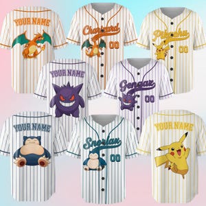 May include: A collection of seven short-sleeved baseball jerseys featuring pinstripes and various Pokémon characters including Charizard, Pikachu, Gengar, and Snorlax. Each jersey displays either the text Your Name or a specific character name and the number 00.