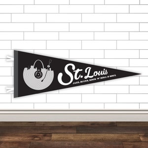 May include: Black and white pennant flag with a vinyl record design featuring the St. Louis skyline and the text "St. Louis Jazz, Blues, Rock 'n' Roll & Soul".