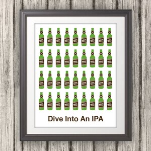 May include: A framed print with a white background and a grid of 48 green beer bottles with brown labels that say "India Pale Ale". The text "Dive Into An IPA" is at the bottom of the print.