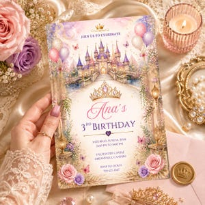 May include: A rectangular birthday invitation card featuring a watercolor illustration of a castle, a gold crown, balloons, and roses. Text reads: JOIN US TO CELEBRATE, Ana's 3RD BIRTHDAY, SATURDAY, JUNE 14, 2026, 2:00 PM TO 5:00 PM, ENCHANTED CASTLE, DREAMVILLE, CA 90210, RSVP TO OLIVIA 555-123-4567.