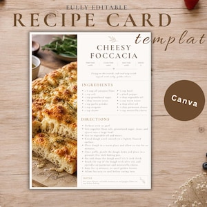May include: A white recipe card template featuring the text "FULLY EDITABLE RECIPE CARD template" and "CHEESY FOCCACIA" with a photograph of baked focaccia bread on the left side, ingredient lists, and cooking directions printed in dark brown text.