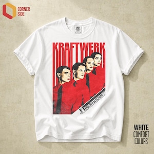 May include: A white short-sleeved t-shirt featuring a graphic print of the band Kraftwerk. The design displays four figures in red shirts and black ties against a red and white striped background with the text KRAFTWERK and DIE MENSCH-MASCHINE.