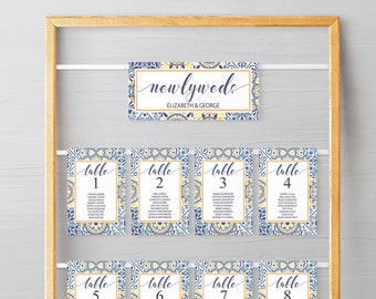 May include: A wooden frame with a white string holding eight table cards with blue and yellow patterned designs. The cards are numbered 1 through 8. The top card says "newlyweds Elizabeth & George".
