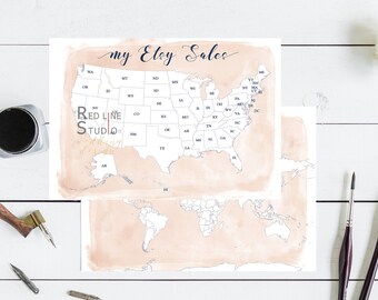 May include: A watercolor map of the United States with each state outlined and labeled. The map is on a light pink background with the text "my Etsy Sales" written in black cursive at the top. The map is on a white wooden surface with a calligraphy pen, inkwell, and paintbrushes.