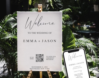 Op de afbeelding: Een wit welkomsbord met zwarte tekst voor een bruiloft. Het bord zegt "Welkom op de bruiloft van Emma + Jason" en bevat de datum "21 november 2021" en de locatie "Westwood, New York". Een QR-code is inbegrepen om het ceremonieprogramma te bekijken.