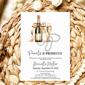 May include: A white card with a gold and white illustration of a bottle of champagne and a glass of champagne with a pearl necklace. The text on the card reads "Pearls & Prosecco" and "Please join us for a bridal shower to celebrate the bride-to-be Danielle Miller Saturday | September 21 | 2035 at 7 o'clock in the evening THE EVENT PUB 123, Main Rd Philadelphia, PA Kindly RSVP to Emma at 333 879 6654 The bride-to-be is registered at "The Bridal Shop"