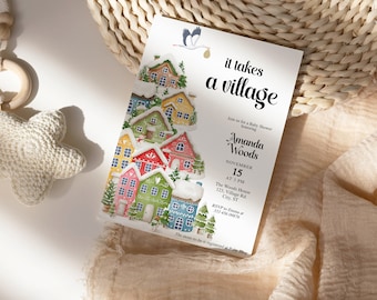 May include: A white baby shower invitation with a watercolor illustration of colorful houses with snow on the roofs. The text "it takes a village" is in a large, bold font. The invitation is for Amanda Woods on November 15th at 3 PM at The Woods House. The address is 121 Village Rd, Cley ST. The RSVP number is 313-456-078.