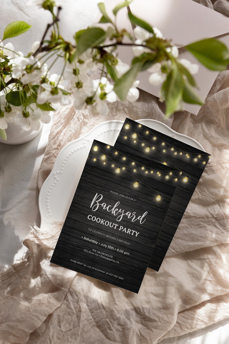 May include: A black and white invitation with a rustic woodgrain background and string lights. The text reads "Please join us for a Backyard Cookout Party to celebrate Michael's Birthday. Saturday, July 10th, 6:00 pm. The Miller House, 123 River Rd, Philadelphia, PA. Kindly RSVP by July 1st to [email protected] or 323-456-7890."