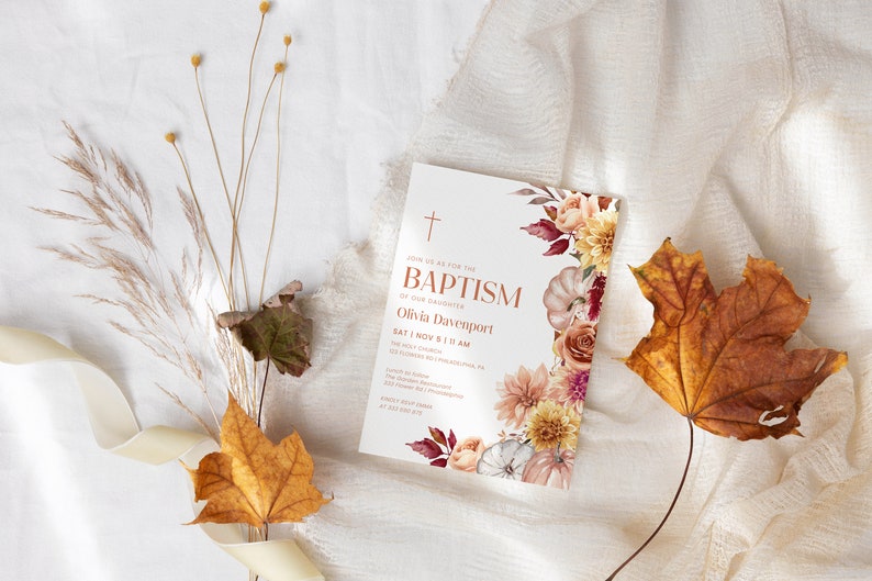 May include: A baptism invitation with a floral design featuring pumpkins, roses, and fall leaves. The invitation reads "Join us as we celebrate the Baptism of our daughter Olivia Davenport Sat 1 Nov 5:11 AM The Holy Cross Church 1234 Church Rd, Somewhere, PA 12345 RSVP by October 15th at 555-555-5555"