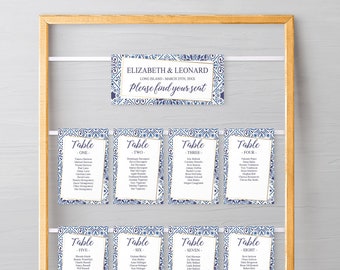May include: A set of eight blue and gold table cards with a decorative pattern. Each card has a table number and a list of names. The top card says "Elizabeth & Leonard, Long Island - March 29th, 20XX, Please find your seat."