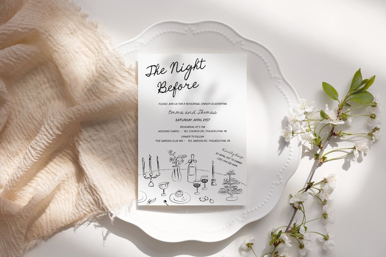 May include: A white invitation card with black text and a hand-drawn illustration of a dinner table setting. The text reads "The Night Before" and includes the names "Emma and Thomas" and the date "Saturday, April 21st".