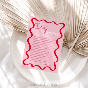 May include: A pink and red printable game card with the title "Dirty Minds". The card features a list of 16 questions with a space to mark points.