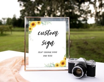 May include: A white sign with a gold frame and sunflowers and greenery around the border. The sign says "custom sign" and "8x10" change font and text".