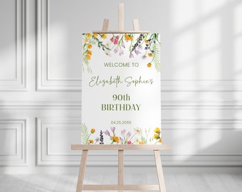 May include: Welcome to Elizabeth Sophie's 90th Birthday sign with a floral design featuring yellow, purple, and white flowers. The date 04.25.2055 is printed on the sign.