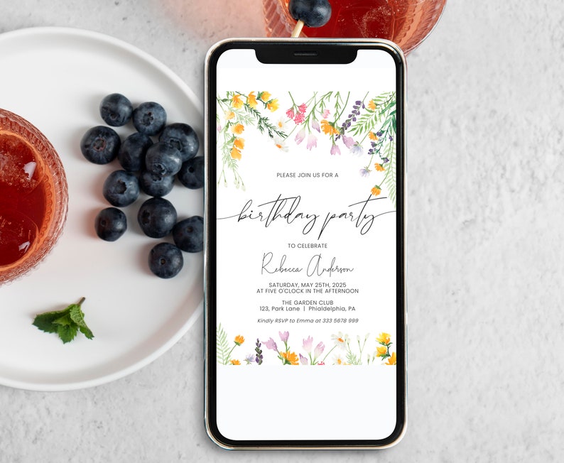 May include: A white and gold smartphone with a floral design on the screen. The screen displays a birthday party invitation for Rebeca Anderson, with the date, time, and location of the party. The text on the invitation reads: "Please join us for a birthday party to celebrate Rebeca Anderson Saturday, May 25th, 2025 at five o'clock in the afternoon The Garden Club 123, Park Lane | Philadelphia, PA Kindly RSVP to Emma at 333 5678 900"