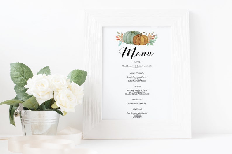 May include: A printable Thanksgiving menu featuring a watercolour illustration of pumpkins and autumn foliage. The menu lists dishes such as mixed greens with balsamic vinaigrette, organic farm-raised turkey, and homemade pumpkin pie.