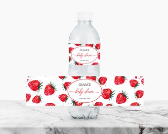 May include: Water bottle label with a white background and red strawberries. The label says "Olivia's Baby Shower" with the date "July 15th, 2017".